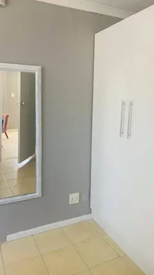 a room with a mirror and a white wall at SpaciousNetflix#Wifi#Parking#CentralWinefarms#Mall in Cape Town