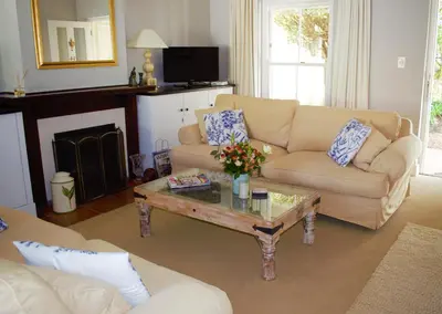 a living room with a couch and a coffee table at Mafunyani Cottage in Franschhoek