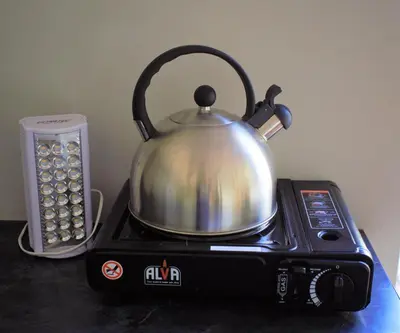 a tea kettle sitting on top of a stove at Mafunyani Cottage in Franschhoek
