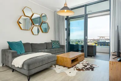 a living room with a couch and a table at The Axis Luxury Apartments in Cape Town