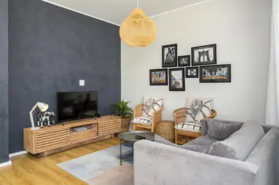 a living room with a couch and a tv at The Axis Luxury Apartments in Cape Town