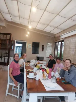 a group of people sitting around a table at Villa Garda B&B in Cape Town