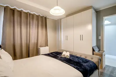 a bedroom with a bed with two shoes on it at Belina - Quayside Canal Front in Cape Town