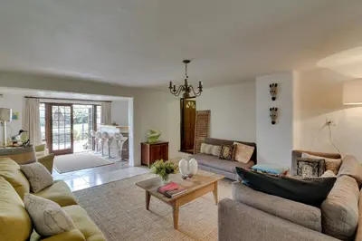 a living room with two couches and a table at De Molen Guest House in Somerset West