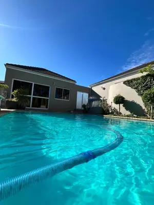 a swimming pool in front of a house at Somerset West All Stay 1 in Somerset West