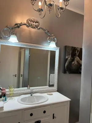 a bathroom with a sink and a mirror at Somerset West All Stay 1 in Somerset West