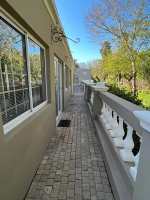 a brick walkway outside of a house with windows at Somerset West All Stay 1 in Somerset West