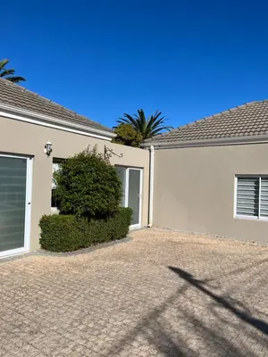 a white house with a bush in front of it at Somerset West All Stay 1 in Somerset West