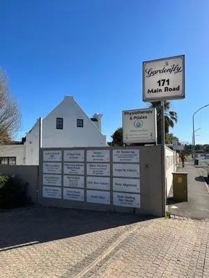 a sign on a wall next to a building at Somerset West All Stay 1 in Somerset West