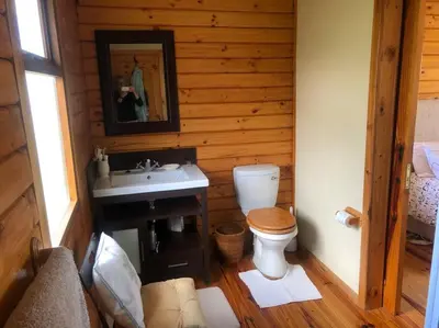 a bathroom with a toilet and a sink in a cabin at Adorable 2 bedroom seaside vacation home in Kleinmond