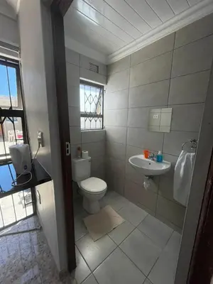 a bathroom with a toilet and a sink at Finca Guest House in Cape Town