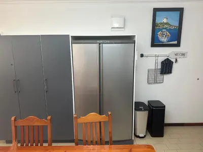 a metal elevator in a room with two chairs at Strelitzia, spacious with a stunning view in Cape Town