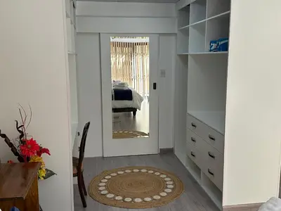 a bedroom with a mirror and a bed at Strelitzia, spacious with a stunning view in Cape Town