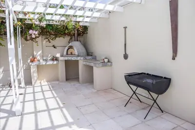 a patio with a table and a pizza oven at A Touch of Country in Stellenbosch