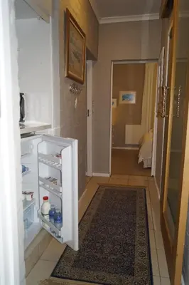an open refrigerator in a room with a bathroom at Valentines Hermanus in Hermanus