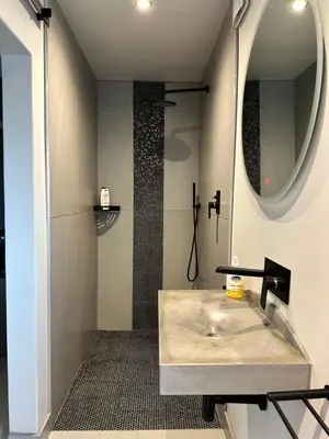 a bathroom with a sink and a mirror at Hidden Gem on Onrus River in Hermanus