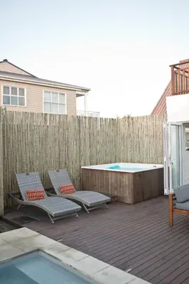 a patio with two chairs and a swimming pool at Villa Del Mar in Clareport