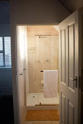 a bathroom with a shower with a white towel at Villa Del Mar in Clareport