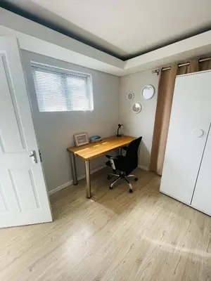 an office with a desk and a chair in a room at Sixth Avenue Residence Halaal Accommodation Cape Town in Cape Town
