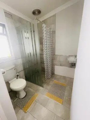 a bathroom with a toilet and a shower at Sixth Avenue Residence Halaal Accommodation Cape Town in Cape Town