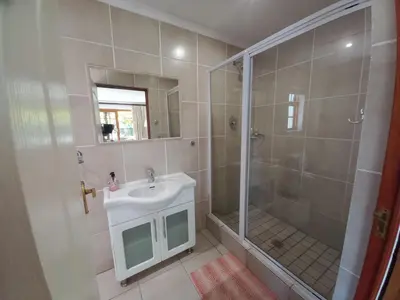 a bathroom with a shower and a sink at Wine Route 44 Guesthouse in Somerset West