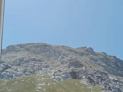 a rocky mountain with a blue sky in the background at Aloe Ocean Flatlet in Bettyʼs Bay