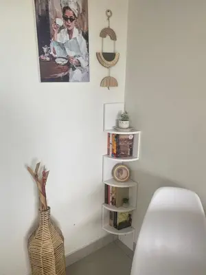 a white room with a vase and a picture on the wall at Seaview Sunset Boutique Apartments Gordonsbay Solar powered in Cape Town