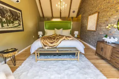 a bedroom with a bed with a tigerebra blanket at Val de Vine in Stellenbosch
