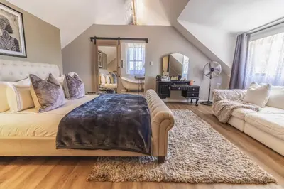 a living room with a bed and a couch at Val de Vine in Stellenbosch