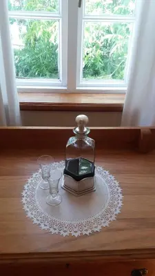 a glass jar with a clock and two glasses on a table at 3 on Roux in Franschhoek