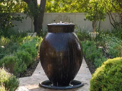 a large vase sitting on a path in a garden at Beulah Lodge in Cape Town