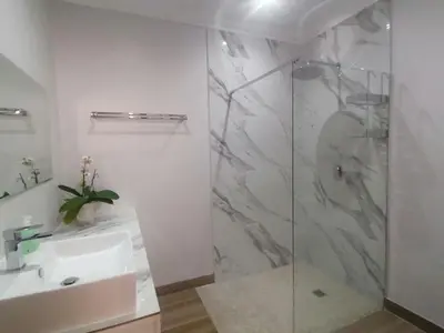 a bathroom with a shower and a sink at Beulah Lodge in Cape Town