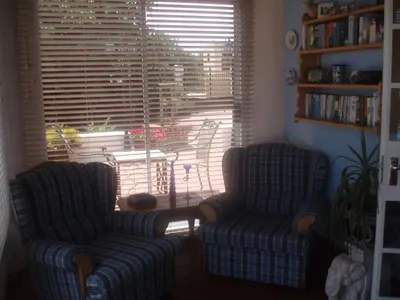 two chairs and a table in a living room at The Sanctuary Guest House Estate in Cape Town