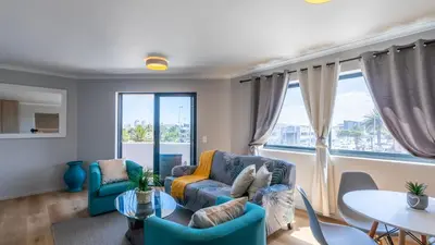 a living room with a couch and a table at Shore2Please in Cape Town
