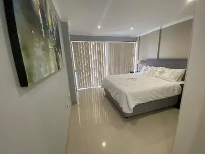 a bedroom with a bed and a window at Nautica 2 Bedroom Beachfront Apartment with Sea Views in Bloubergstrand