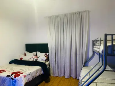 a bedroom with two bunk beds and a window at Peaceful getaway in Cape Town