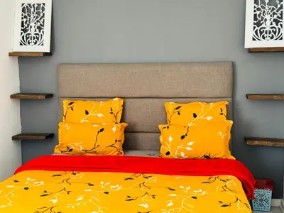 a bedroom with a bed with yellow sheets and pillows at Peaceful getaway in Cape Town