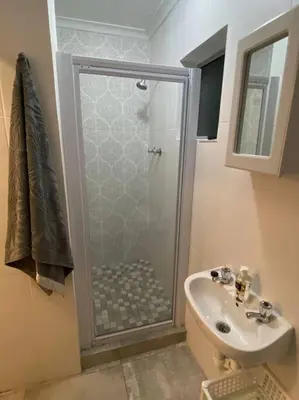 a bathroom with a shower and a sink at Huis by die See in Hermanus