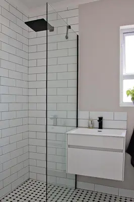 a white bathroom with a shower and a sink at Aloe Aloe Cottage in Cape Town