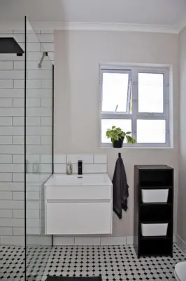 a bathroom with a white sink and a window at Aloe Aloe Cottage in Cape Town