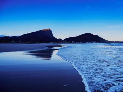 a view of a beach with a mountain in the background at 82 Steps to the Beach in Pringle Bay
