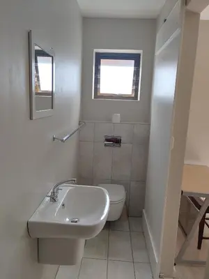 a white bathroom with a sink and a toilet at TERRA NOVA ACCOMMODATION - Unit Esmé in Cape Town