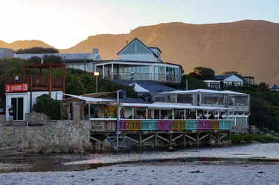 a restaurant on a pier next to the water at C'estÇa Cottage Modern Luxurious Sounds of the Sea in Hermanus