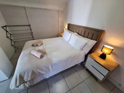 a bedroom with a bed with two towels on it at Little Miracle in Worcester