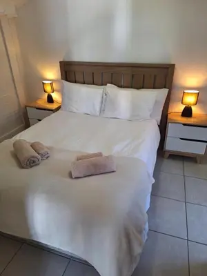 a bedroom with a large bed with two towels on it at Little Miracle in Worcester
