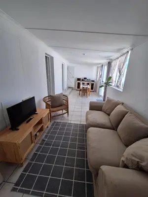 a living room with a couch and a flat screen tv at Little Miracle in Worcester