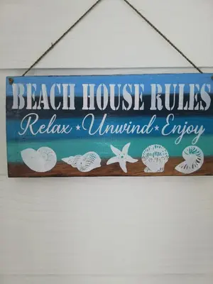 a sign that reads beach house rules relais unwanted envy at Glenley place in Hermanus