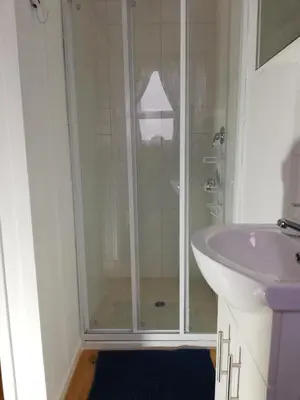 a bathroom with a shower and a sink at Glenley place in Hermanus