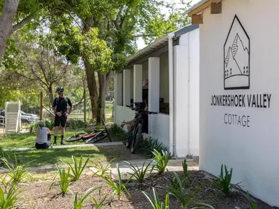 a man standing in front of a building at Jonkershoek Valley Cottage in Stellenbosch