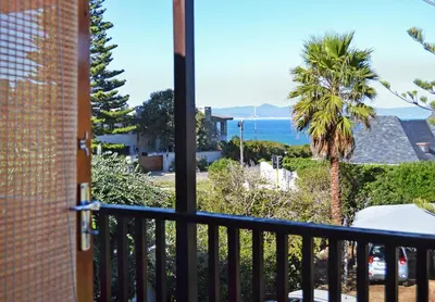 a view of the ocean from the balcony of a house at Chesham House in Hermanus